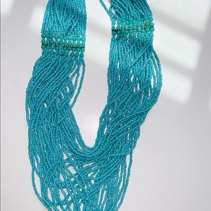 Aqua beaded layered necklace with a gold accent